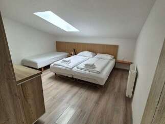 This cozy room features a comfortable bed and a single bed, perfect for a relaxing stay.