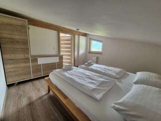 Cozy bedroom with a comfortable bed and fresh linens.