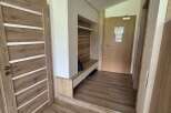 Step into this inviting entryway, featuring stylish wooden doors and flooring that exude warmth.