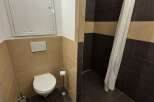 This bathroom features a modern design with a sleek toilet and stylish tile work.