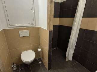 This bathroom features a modern design with a sleek toilet and stylish tile work.