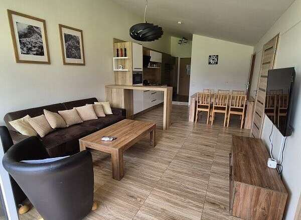 This stunning property boasts a modern living space with a comfortable sofa and stylish armchair.