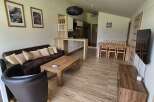 This stunning property boasts a modern living space with a comfortable sofa and stylish armchair.