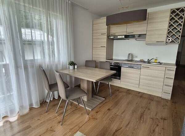 This cozy kitchen features modern cabinetry and a sleek design.