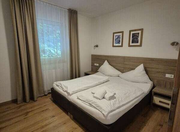 Cozy bedroom with a comfortable double bed, perfect for a relaxing stay.