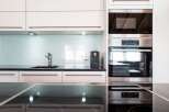 Modern kitchen design featuring sleek white cabinetry and a stylish black countertop.