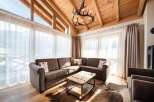 Experience luxury living in this stunning property, featuring a cozy living room with a comfortable sectional sofa and a rustic coffee table.
