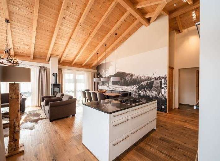 Experience luxury living in this stunning property, featuring a spacious open-plan design with a modern kitchen island.