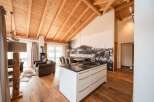 Experience luxury living in this stunning property, featuring a spacious open-plan design with a modern kitchen island.