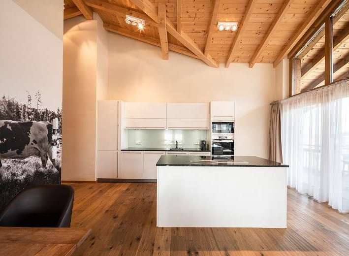 Experience modern living in this stunning kitchen with a sleek island and contemporary design.