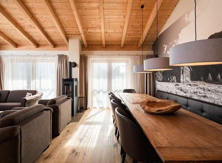 Experience rustic charm in this stunning property, featuring a warm wooden ceiling and inviting living spaces.