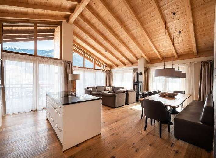 Experience luxury living in this stunning property, featuring a spacious open-plan design with a modern kitchen island.