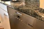 This stunning kitchen boasts a sleek, modern design with a beautiful granite countertop.