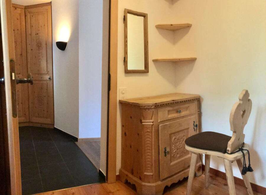 This charming property features a warm and inviting entryway with wooden accents.