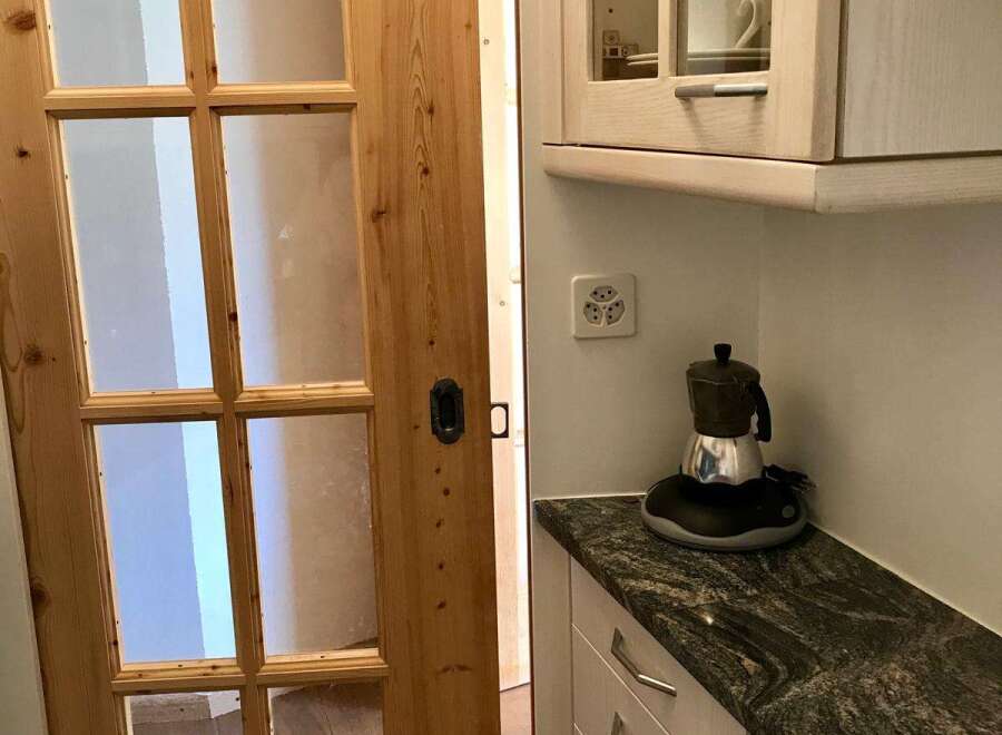 This charming property boasts a beautifully designed kitchen with a stylish granite countertop.