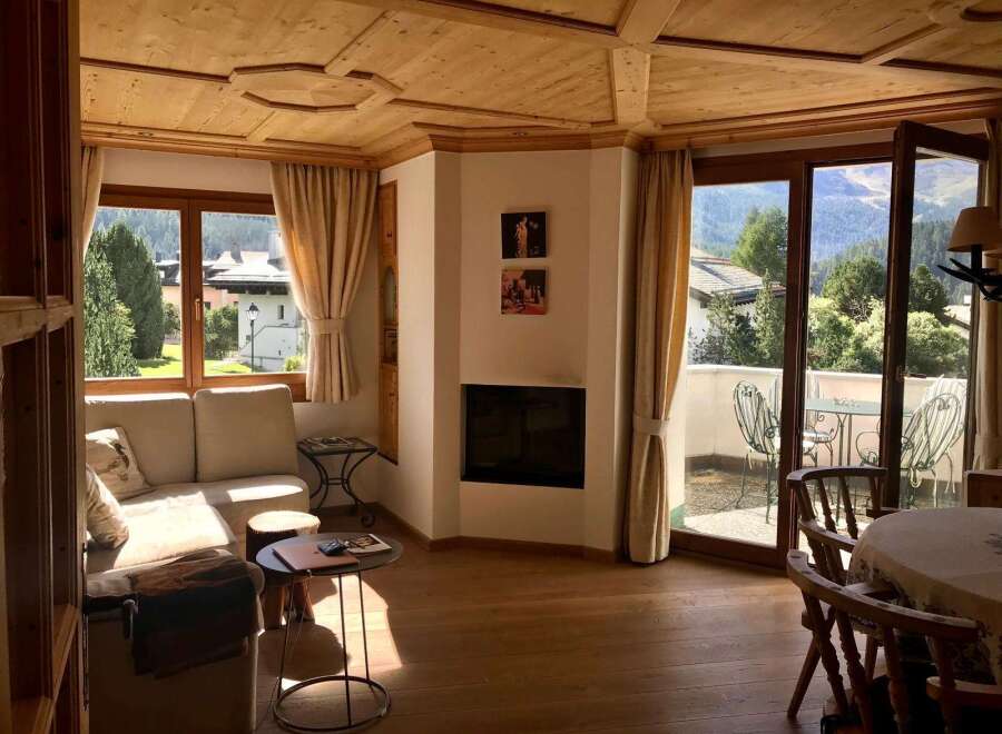 Experience the charm of this cozy living space, featuring a stunning wooden ceiling and inviting natural light.