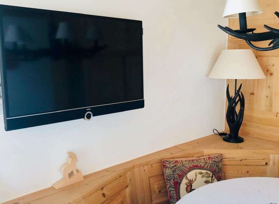 Cozy corner with a mounted TV, perfect for relaxing.