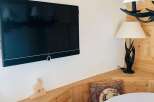 Cozy corner with a mounted TV, perfect for relaxing.