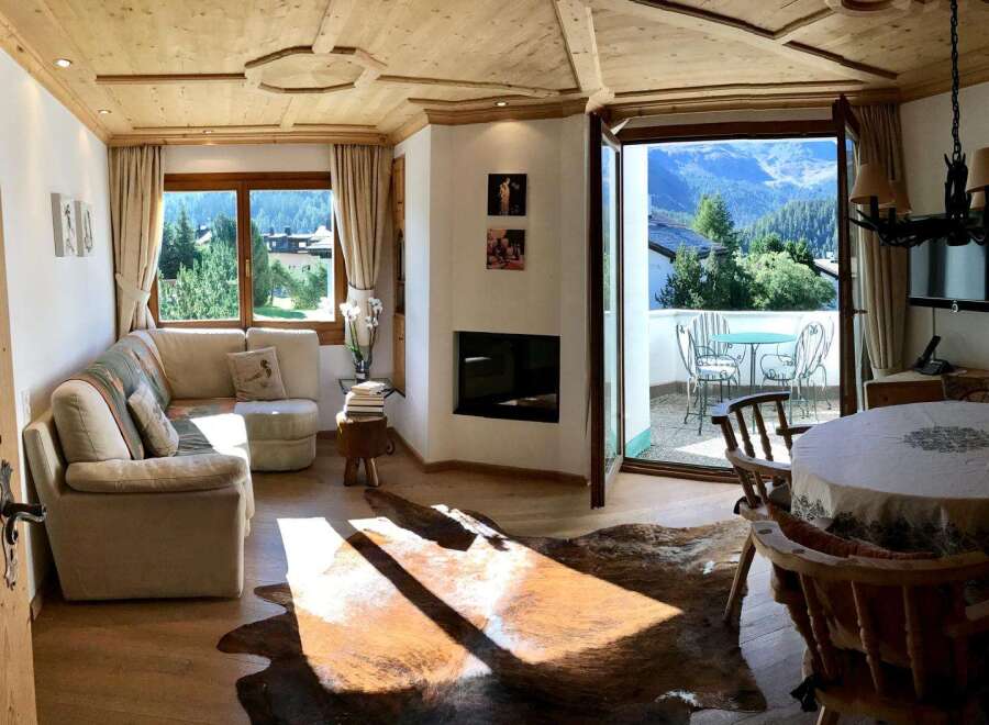 Experience the charm of this cozy living space, featuring a stunning fireplace and a warm, inviting atmosphere.