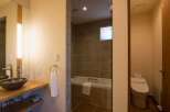This luxurious bathroom boasts a spacious walk-in shower with modern fixtures and a sleek, minimalist design.
