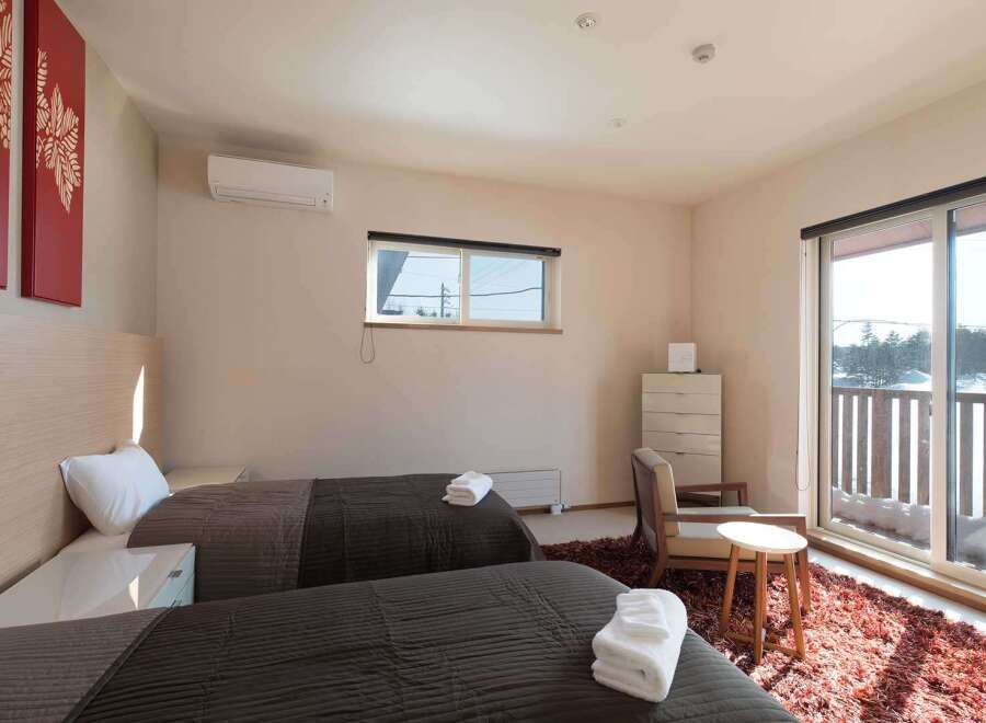 This cozy bedroom features two twin beds with plush bedding, perfect for a relaxing stay.