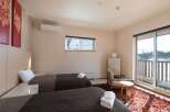 This cozy bedroom features two twin beds with plush bedding, perfect for a relaxing stay.