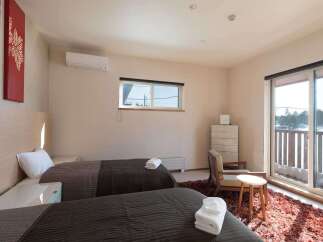 This cozy bedroom features two twin beds with plush bedding, perfect for a relaxing stay.