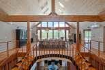 This stunning home boasts a spacious open-plan design with a magnificent vaulted ceiling and large windows offering breathtaking views.