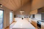 This stunning kitchen boasts a spacious island with white countertops, perfect for meal prep and entertaining.