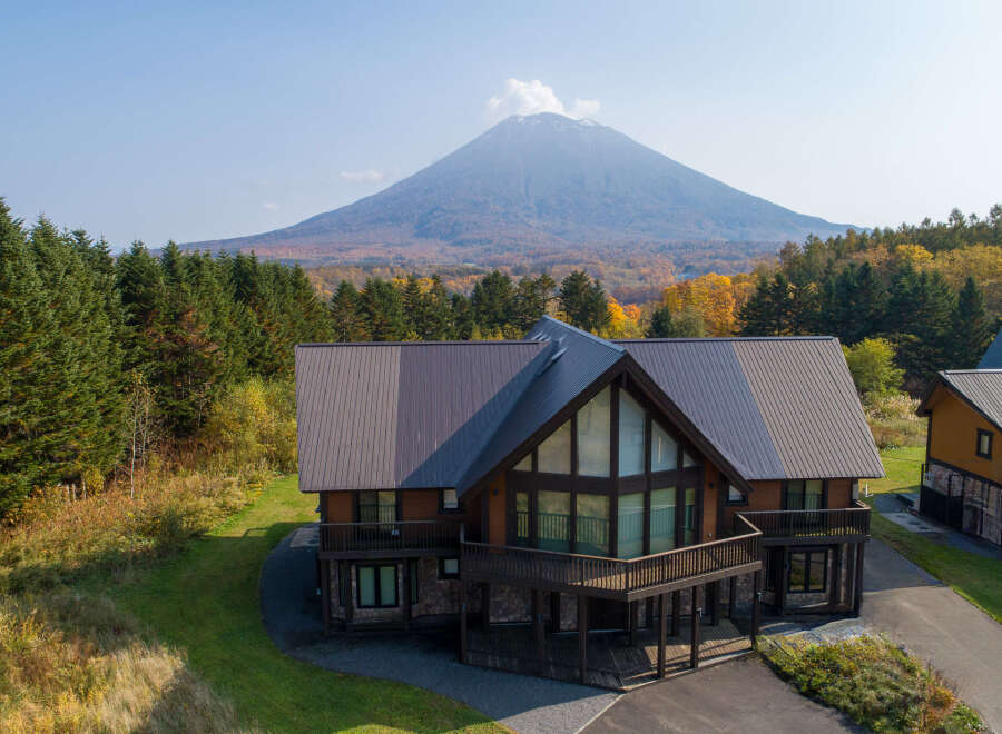 This stunning log cabin boasts a spacious layout with expansive windows offering breathtaking views of the surrounding mountain landscape.