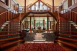 This stunning property boasts a unique architectural design, featuring two elegant curved staircases that frame a serene interior courtyard.