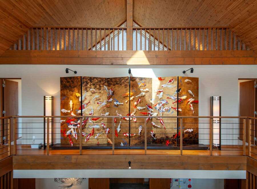 This stunning property boasts a spacious upper hallway with a captivating koi pond-themed artwork as a centerpiece.