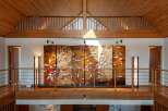 This stunning property boasts a spacious upper hallway with a captivating koi pond-themed artwork as a centerpiece.