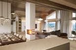 This stunning chalet boasts an open-plan living area with a cozy fireplace, perfect for entertaining guests.