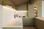 This modern kitchen boasts a sleek design with light beige countertops and olive green cabinetry.