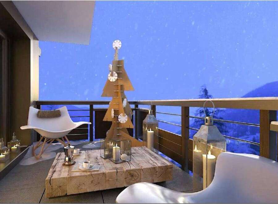 Cozy balcony with stunning mountain views, perfect for enjoying a winter evening.