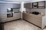 Modern kitchen with sleek gray cabinets and integrated appliances.