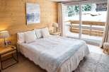Wake up to breathtaking mountain views from this cozy bedroom.