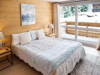 Wake up to breathtaking mountain views from this cozy bedroom.
