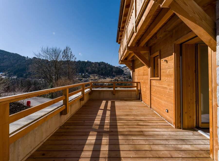 Enjoy breathtaking mountain views from this stunning wooden deck.