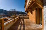 Enjoy breathtaking mountain views from this stunning wooden deck.