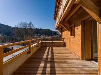 Enjoy breathtaking mountain views from this stunning wooden deck.
