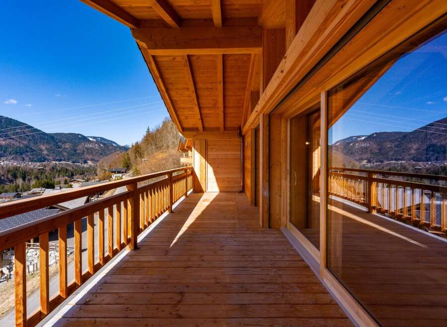 Experience breathtaking mountain views from this stunning wooden balcony.