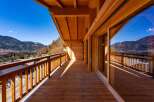 Experience breathtaking mountain views from this stunning wooden balcony.