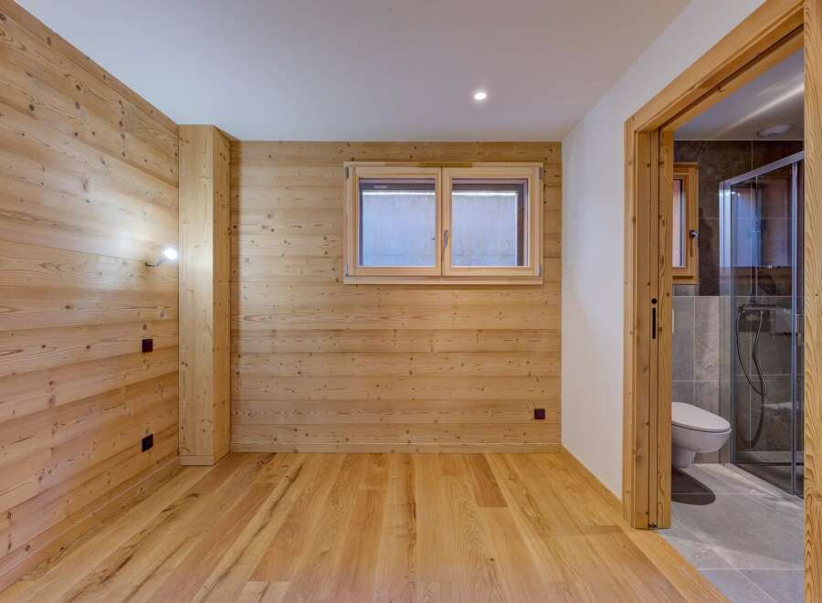 This stunning property boasts a warm and inviting interior with beautiful wooden accents throughout.