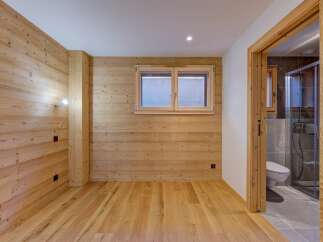 This stunning property boasts a warm and inviting interior with beautiful wooden accents throughout.