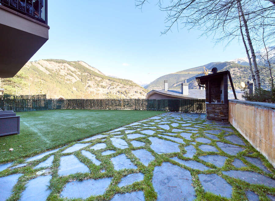 This stunning property boasts a private garden with a beautiful stone patio, perfect for outdoor entertaining.
