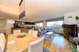 Stunning open-plan living space with modern kitchen, dining area, and comfortable lounge.
