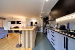 Stunning open-plan kitchen and living area with sleek modern design.