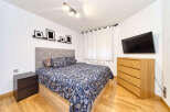 Bright and airy bedroom with a comfortable double bed, featuring a stylish paisley duvet cover.